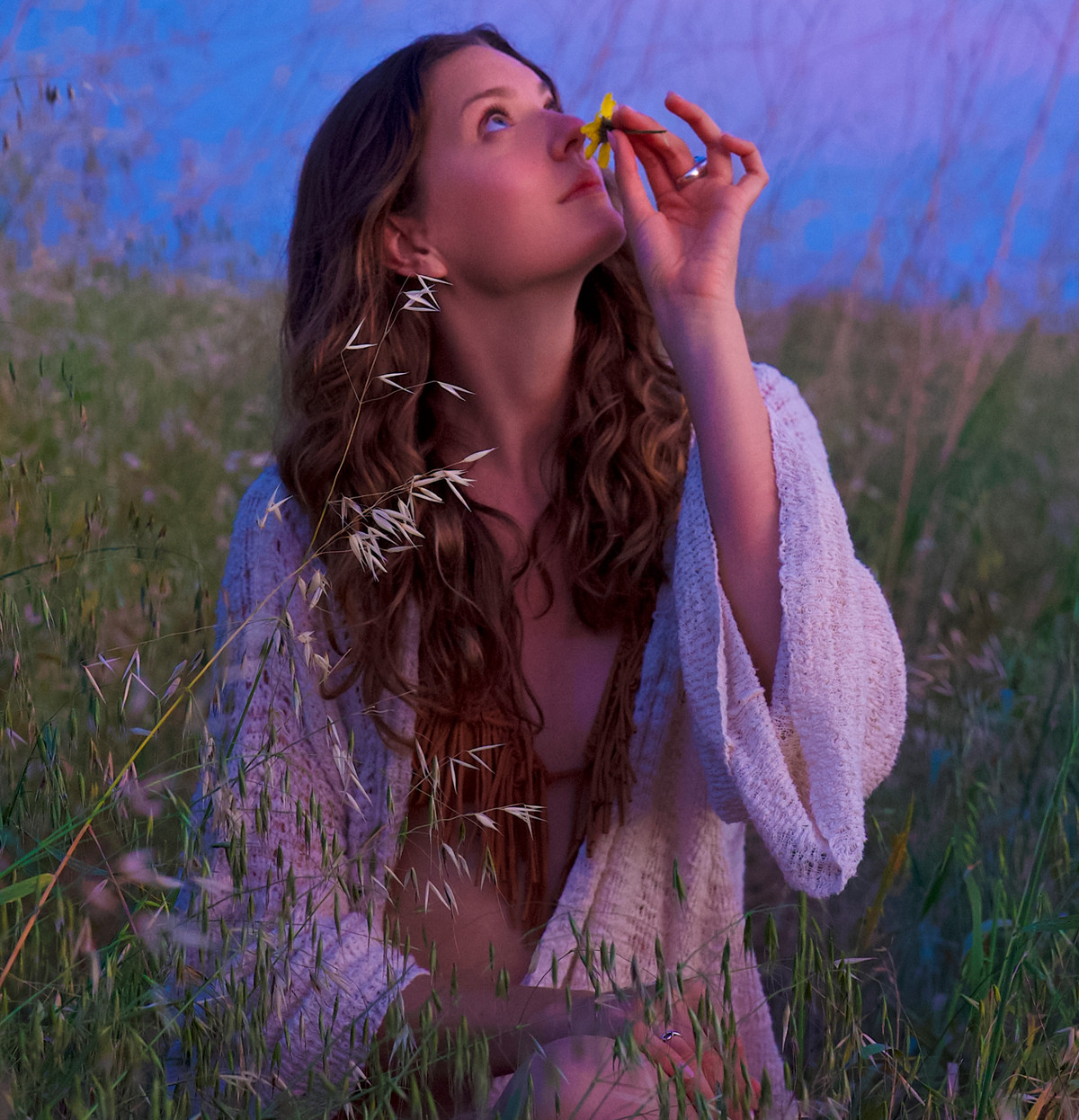 Lindsey sitting in a field